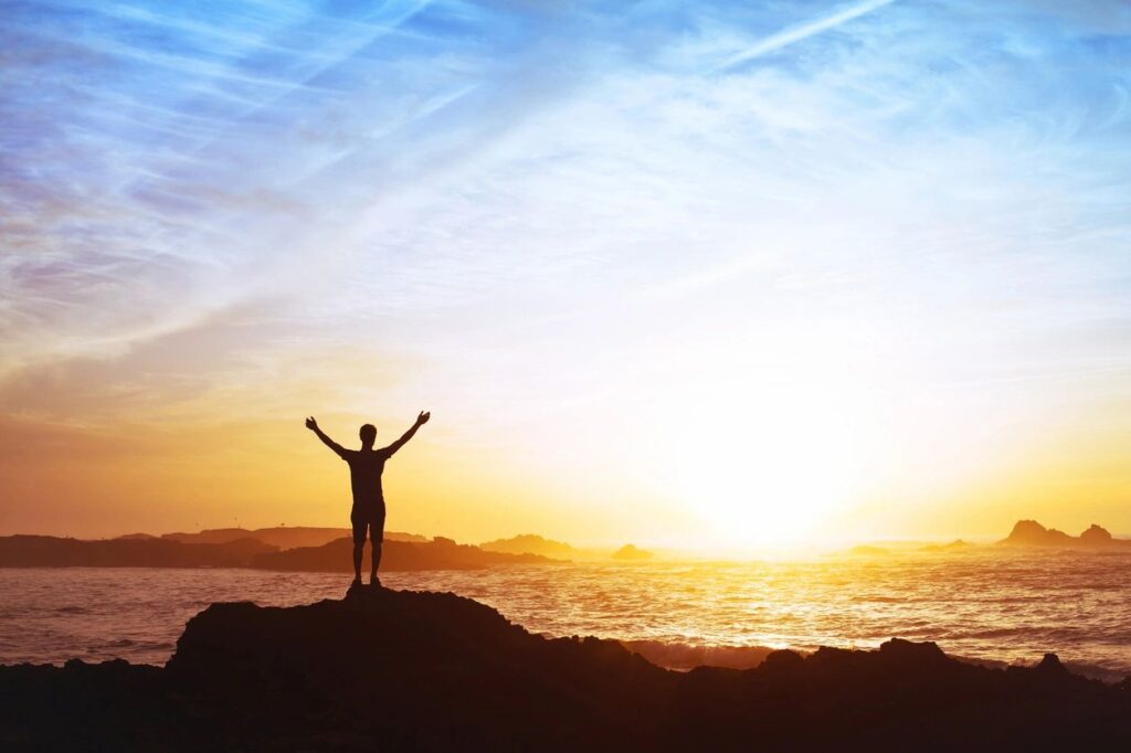 Sunset hands raised