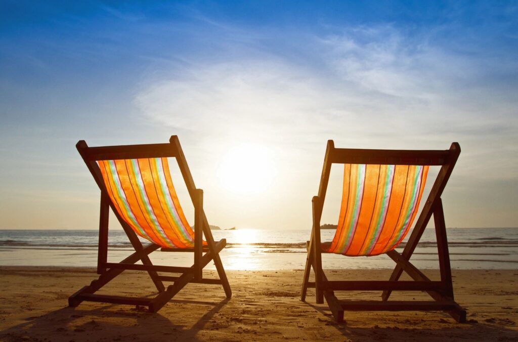 Two beach chairs at sunset